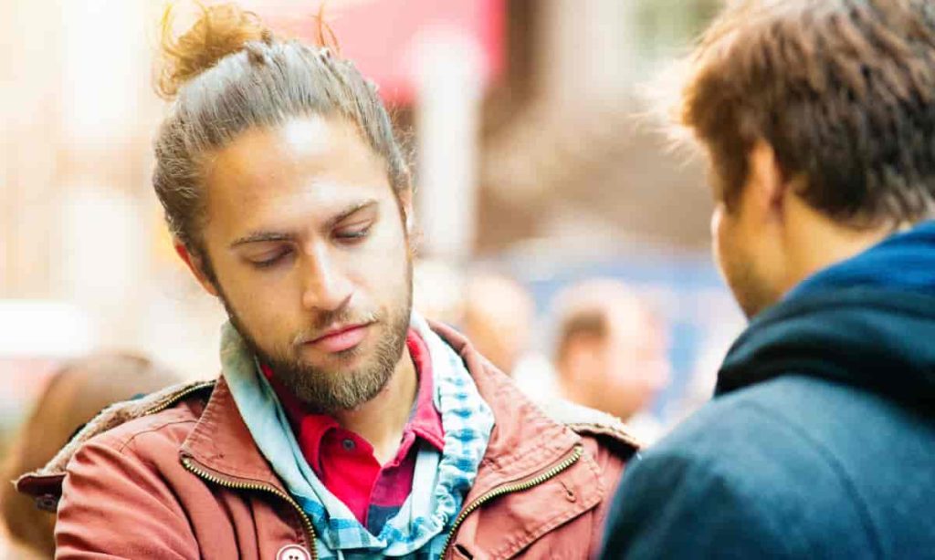 man looking down during conversation
